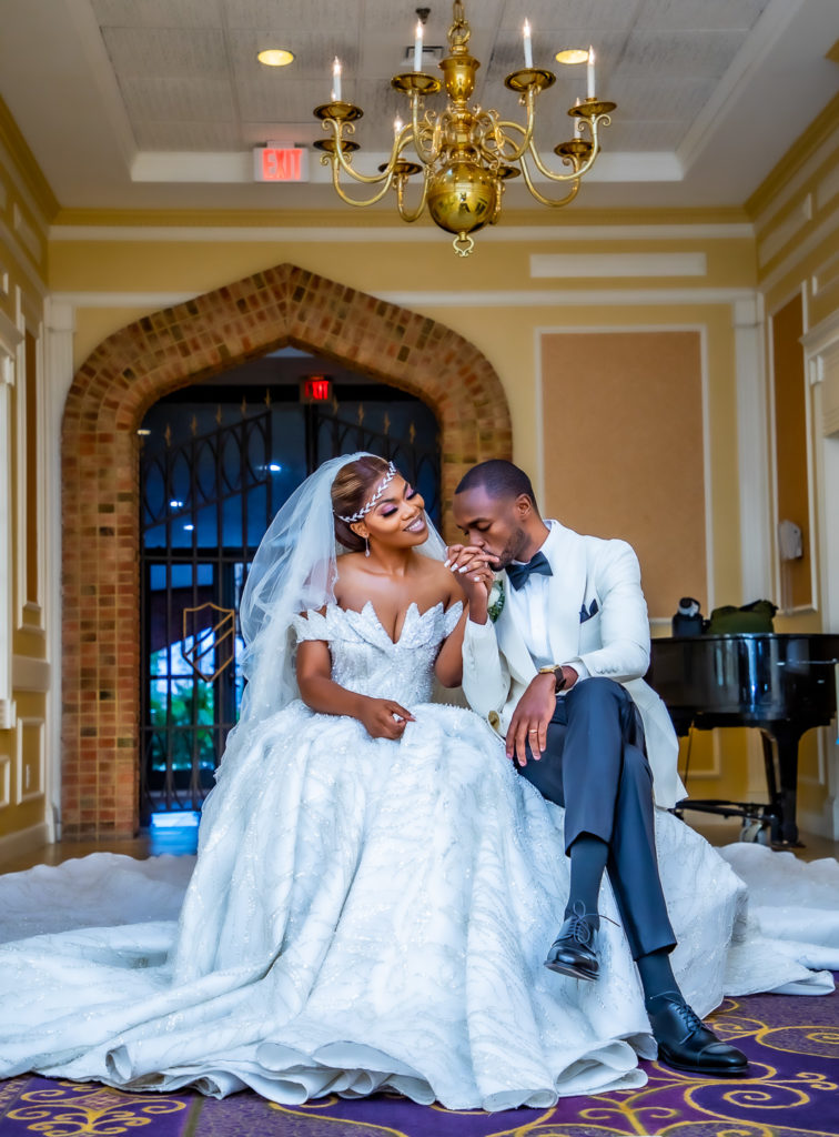 Congolese bride and groom wedding portraits in front of piano at the Radisson hotel in Nashua, NH