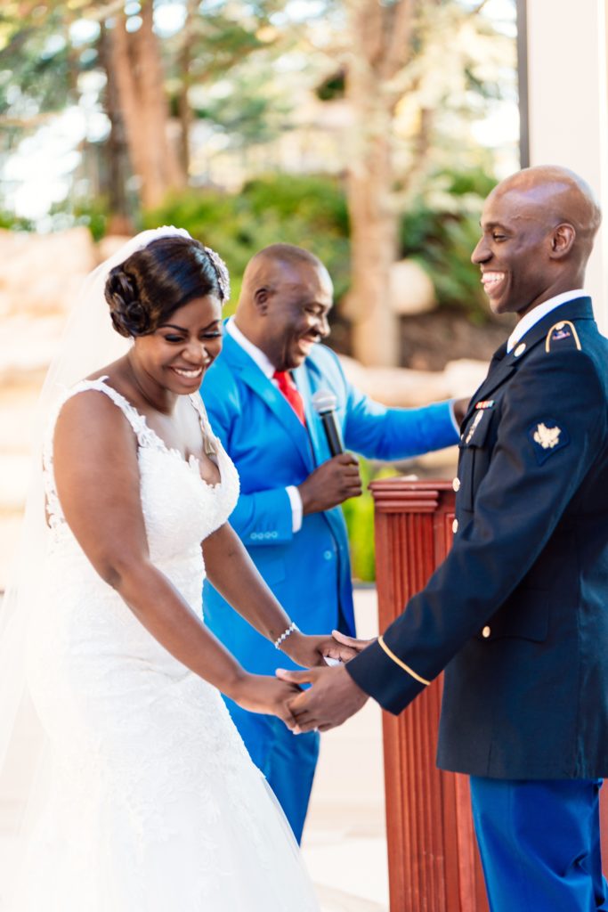 Ivoirian groom and Congolese bride laughing at their wedding ceremony