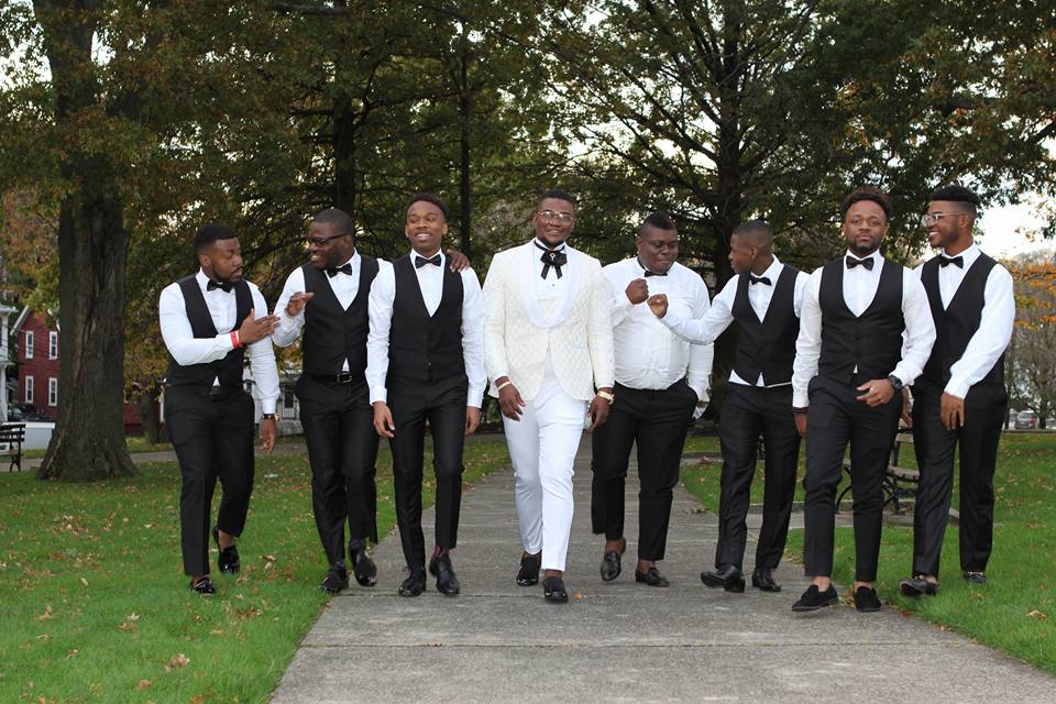 Congolese groom and groomsmen walking through park in Malden, MA